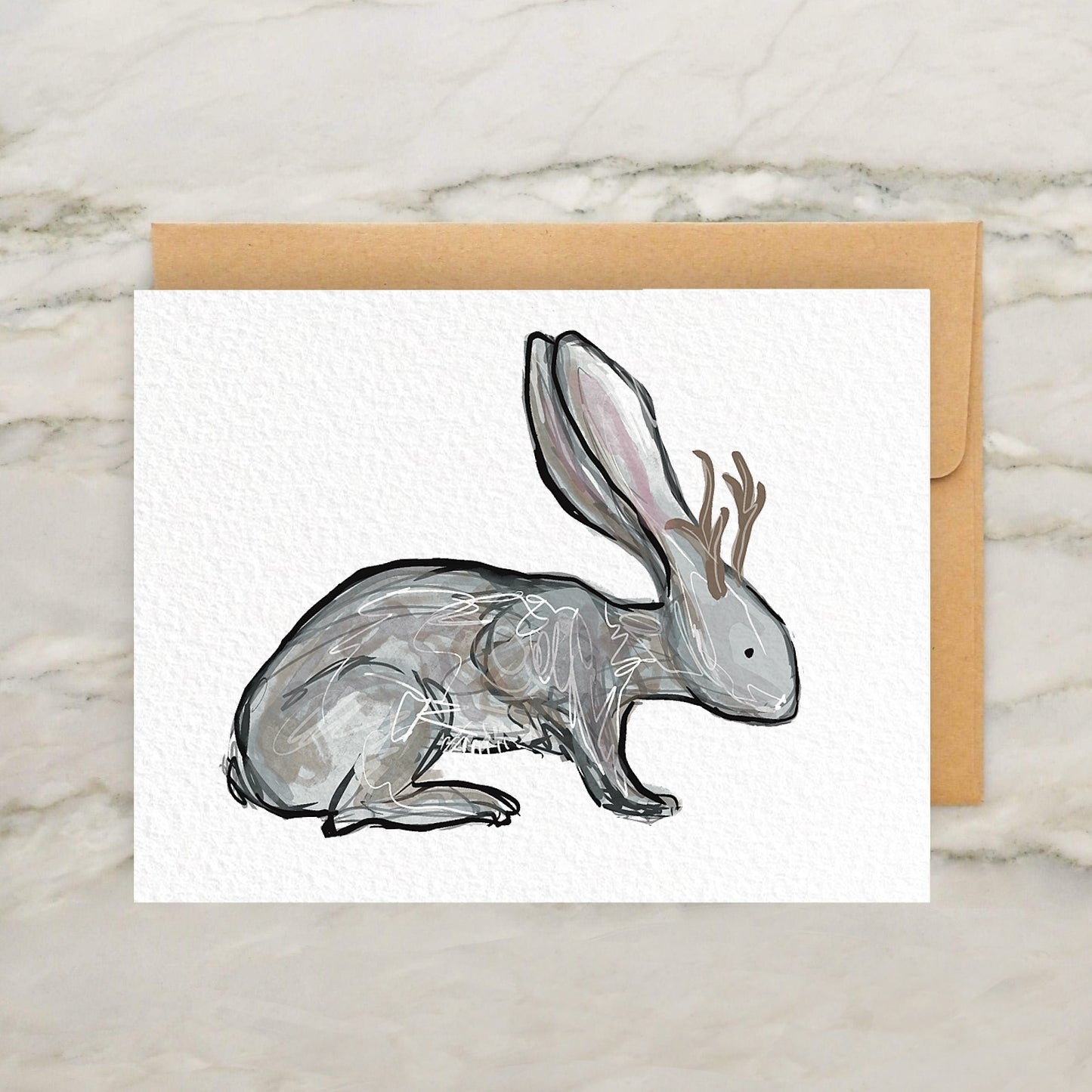 a card with a drawing of a rabbit with antlers on its head
