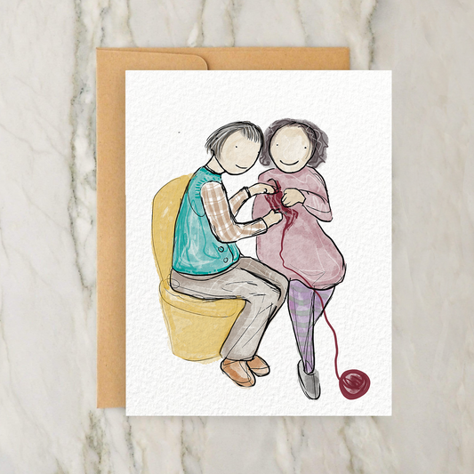 a card with a drawing of two people sitting on a chair